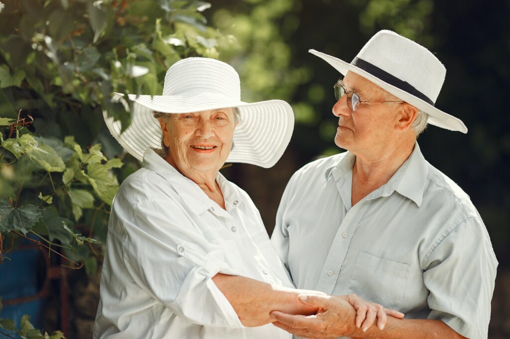 Beautiful old couple spend time in a summer garden